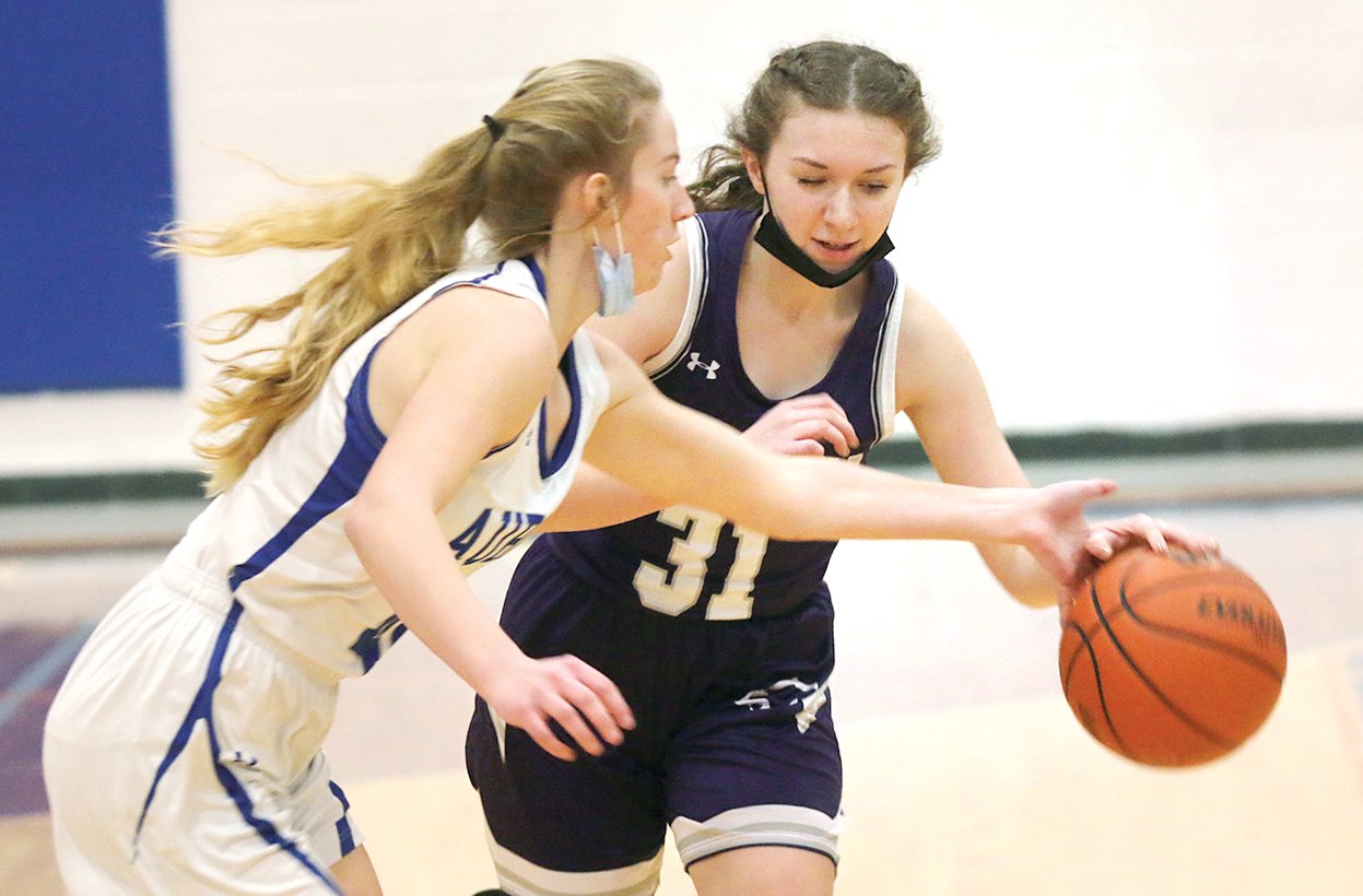 Litchfield's Emma Diveley tries to avoid the pressure of Auburn defender Chloe Crissey during the Panthers' pool play game at the Riverton Christmas Classic on Tuesday, Dec. 28. The Panthers would fall to Auburn and Mt. Pulaski in pool play, but defeated Decatur Lutheran to earn a spot in the ninth place bracket.